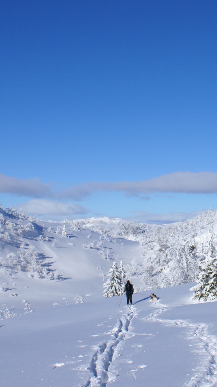 Person Walking on Snow Covered Mountain During Daytime. Wallpaper in 720x1280 Resolution