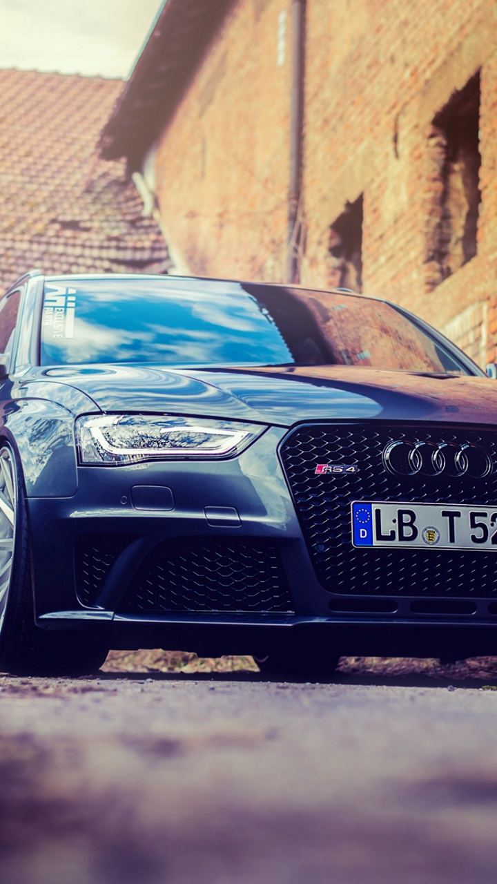 Black Audi r 8 Parked Beside Brown Brick Wall. Wallpaper in 720x1280 Resolution