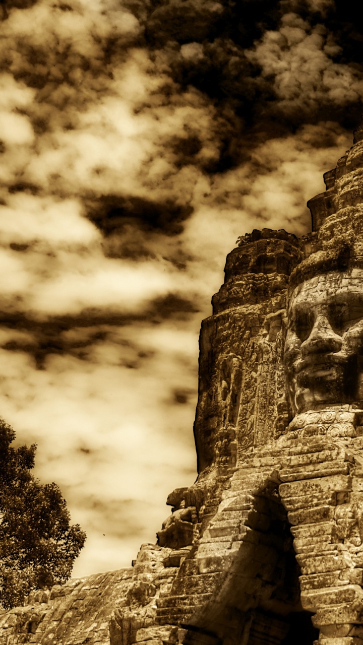 Brown Rock Formation Under Cloudy Sky. Wallpaper in 720x1280 Resolution