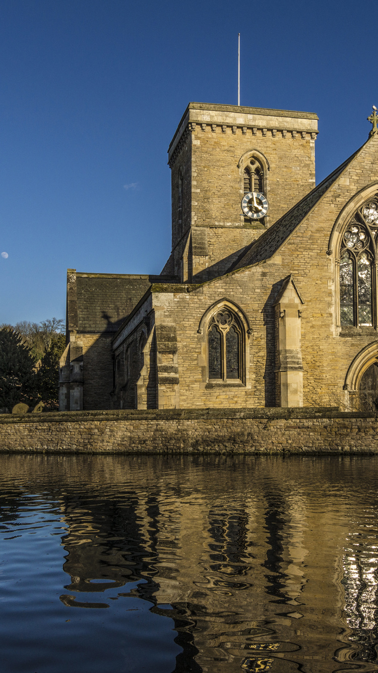 Brown and Gray Concrete Church Near River During Daytime. Wallpaper in 750x1334 Resolution