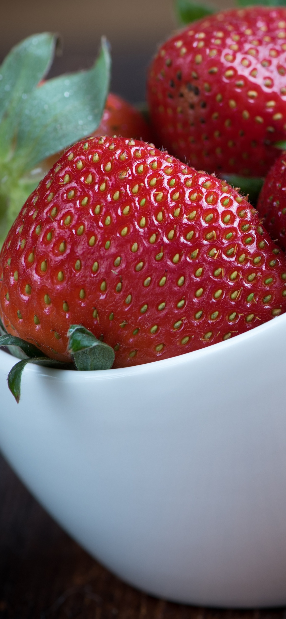 Red Strawberries in White Ceramic Bowl. Wallpaper in 1125x2436 Resolution