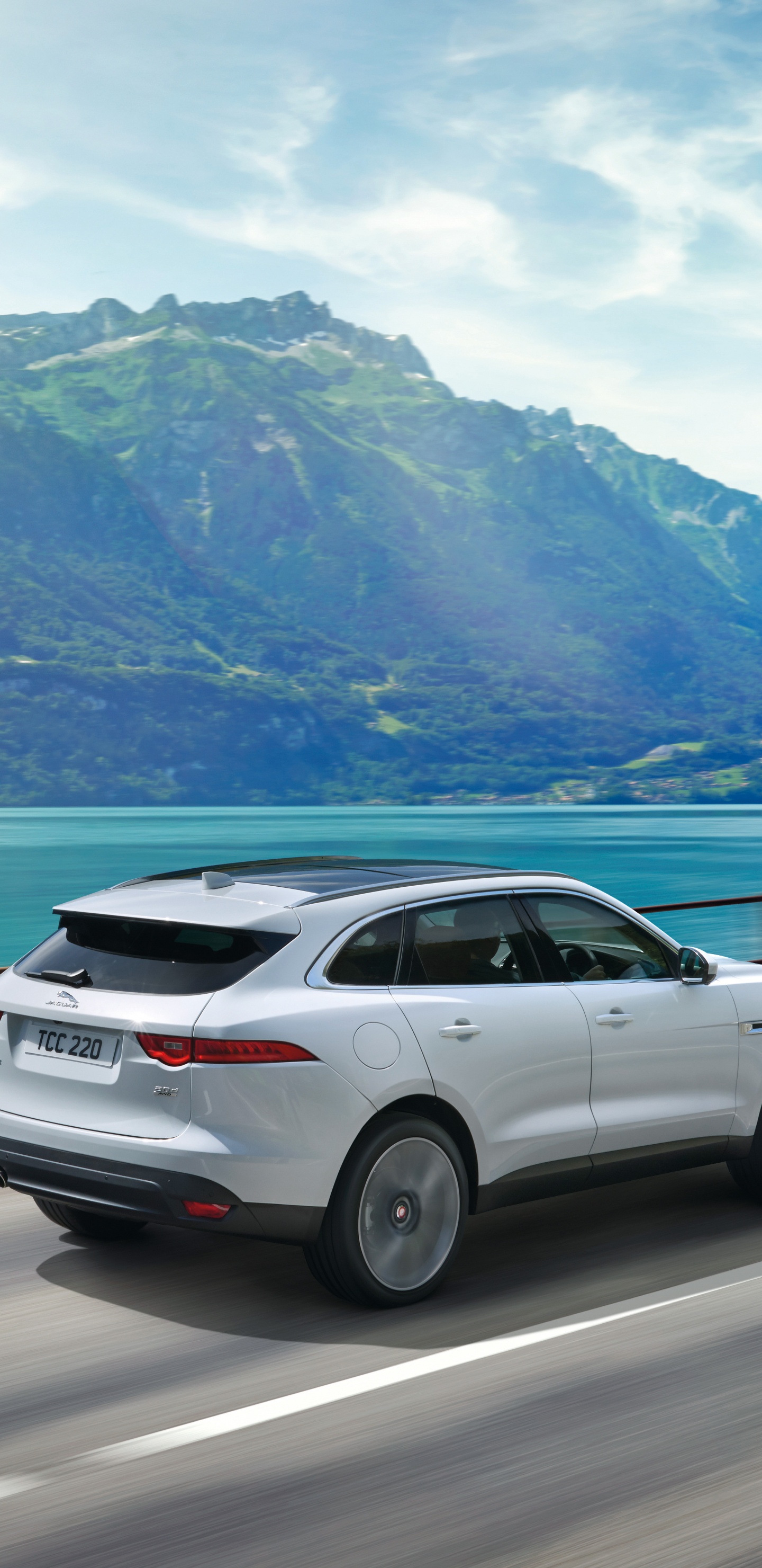 Suv Blanco en la Carretera Cerca Del Cuerpo de Agua Durante el Día. Wallpaper in 1440x2960 Resolution