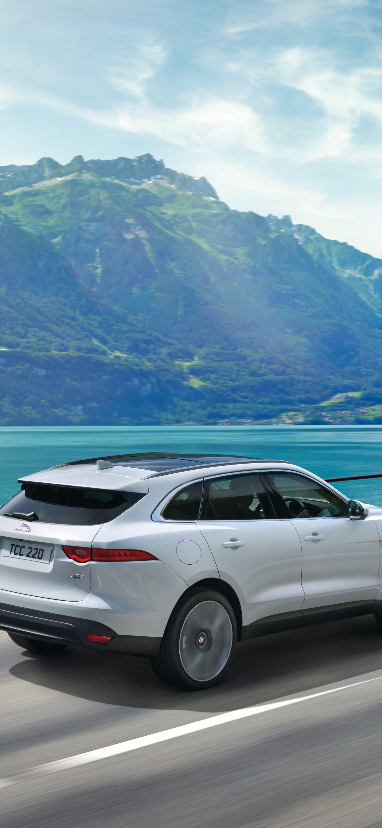 White Suv on Road Near Body of Water During Daytime. Wallpaper in 1242x2688 Resolution