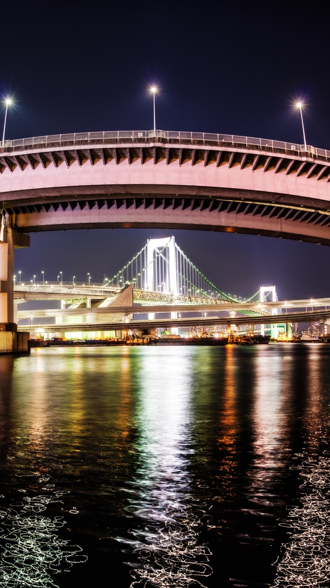 Weiße Und Braune Brücke Über Dem Gewässer Während Der Nacht. Wallpaper in 1080x1920 Resolution