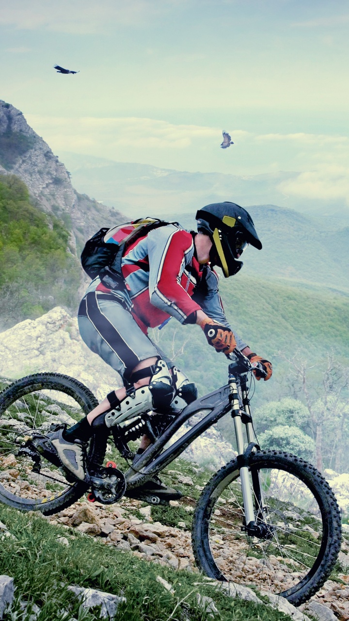 Man in Orange Shirt Riding Bicycle on Mountain During Daytime. Wallpaper in 720x1280 Resolution