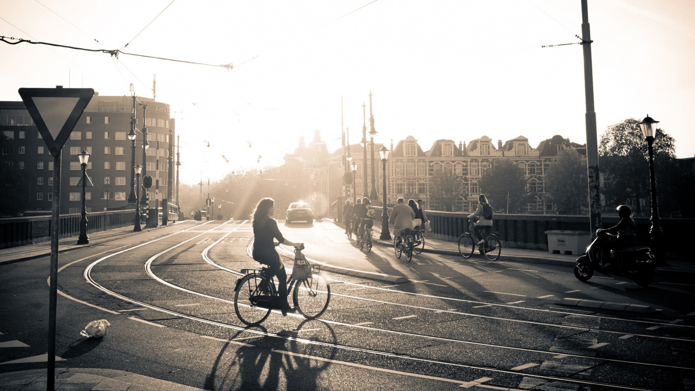 Grayscale Photo of Man Riding Bicycle on Road. Wallpaper in 1366x768 Resolution