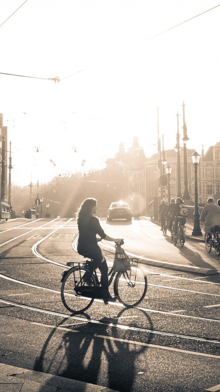 Grayscale Photo of Man Riding Bicycle on Road. Wallpaper in 720x1280 Resolution