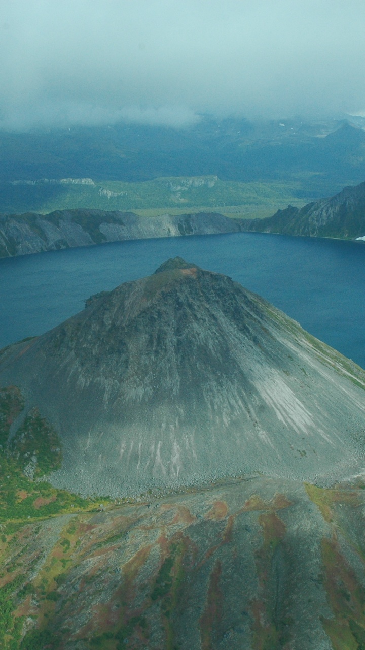 Brown and Green Mountain Beside Blue Sea During Daytime. Wallpaper in 720x1280 Resolution