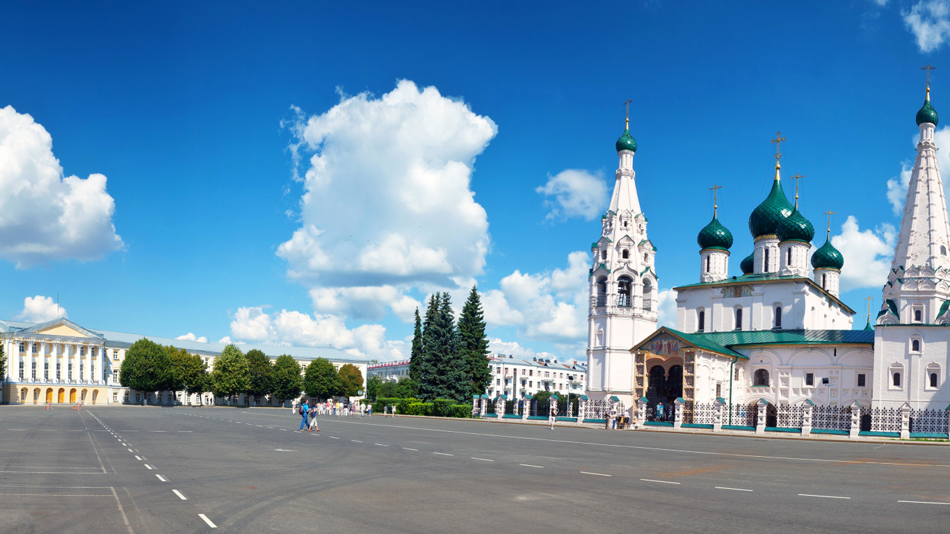 White and Green Concrete Building Under Blue Sky During Daytime. Wallpaper in 1366x768 Resolution