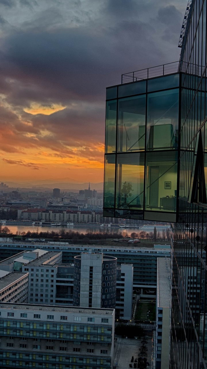 City Skyline Under Cloudy Sky During Sunset. Wallpaper in 720x1280 Resolution