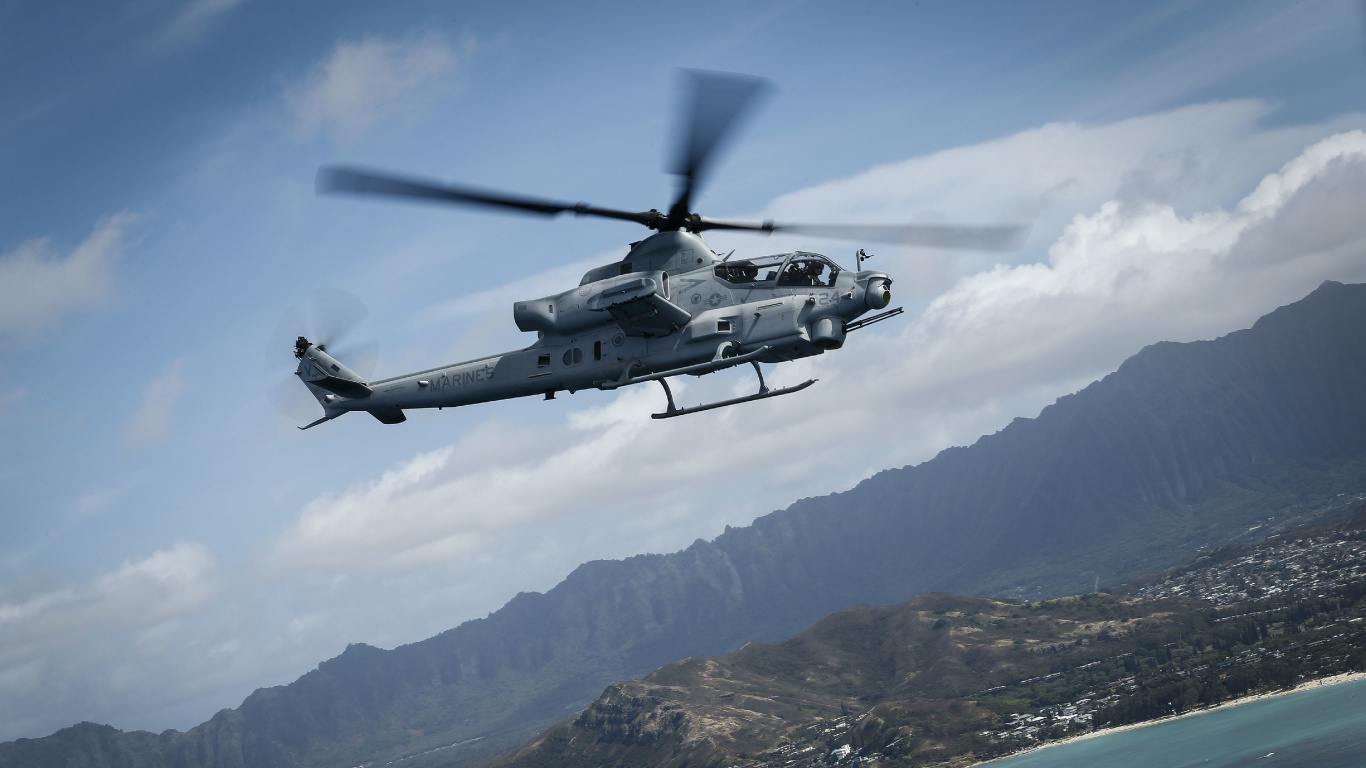 Black and White Helicopter Flying Over The Mountain During Daytime. Wallpaper in 1366x768 Resolution