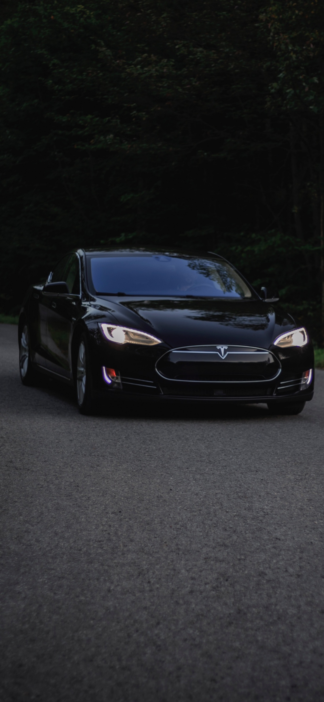 Black Car on Gray Asphalt Road. Wallpaper in 1125x2436 Resolution