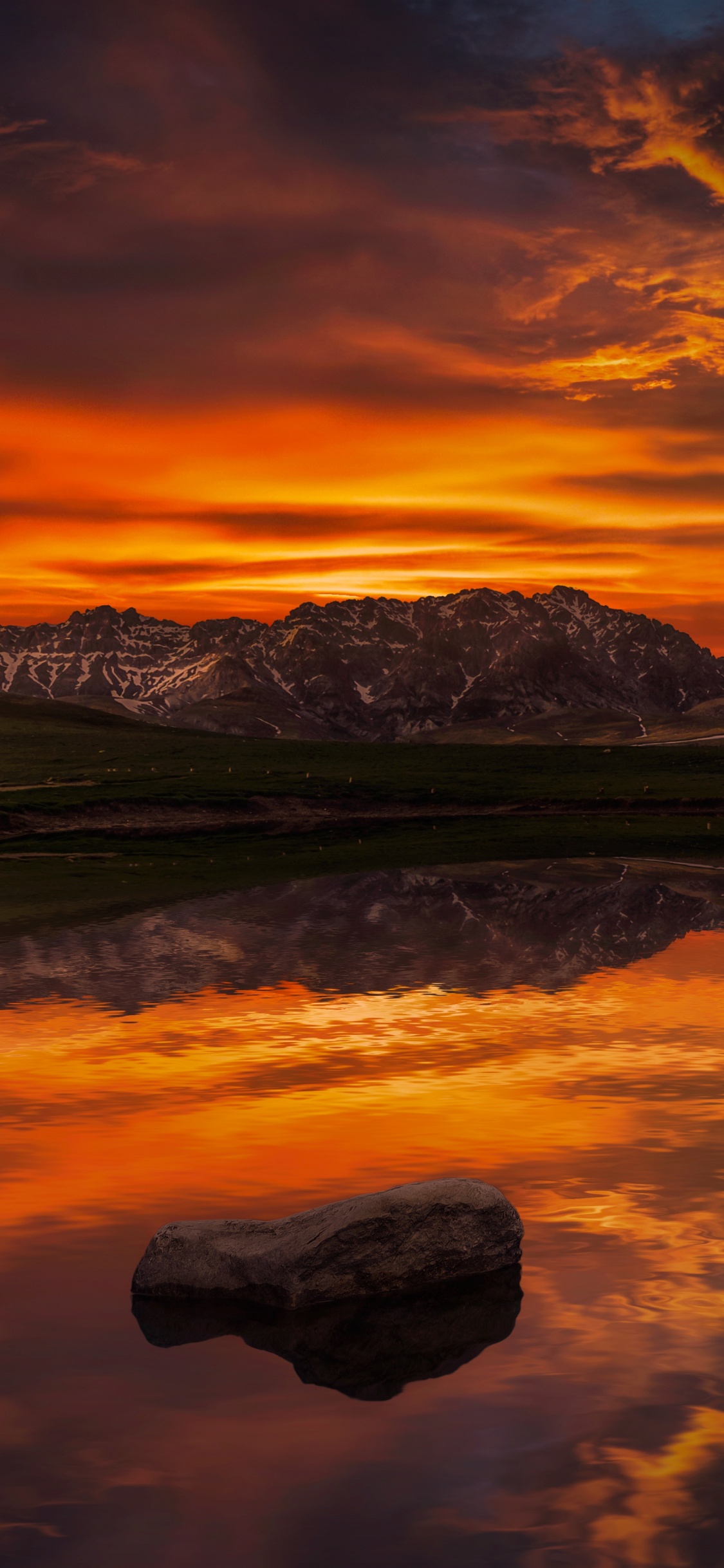 Snow Covered Mountain Near Body of Water During Daytime. Wallpaper in 1125x2436 Resolution