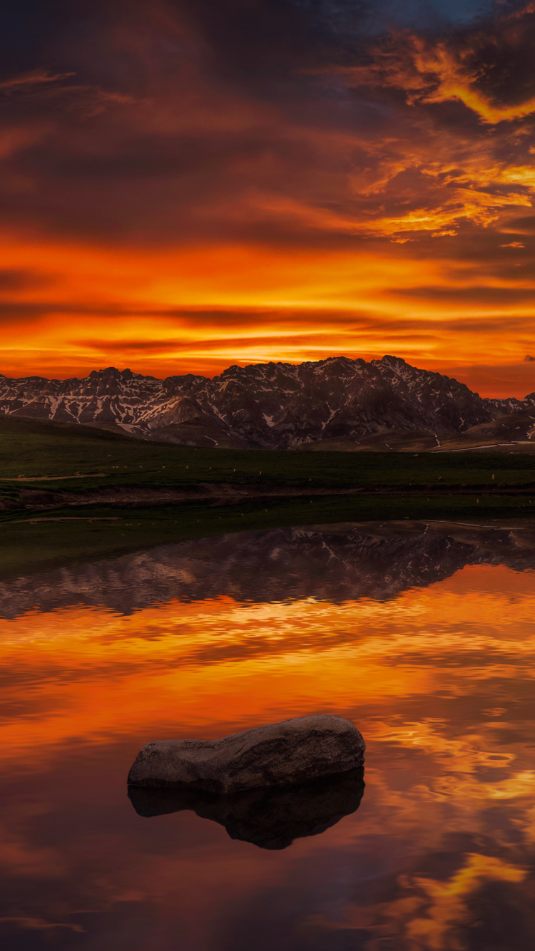 Snow Covered Mountain Near Body of Water During Daytime. Wallpaper in 750x1334 Resolution