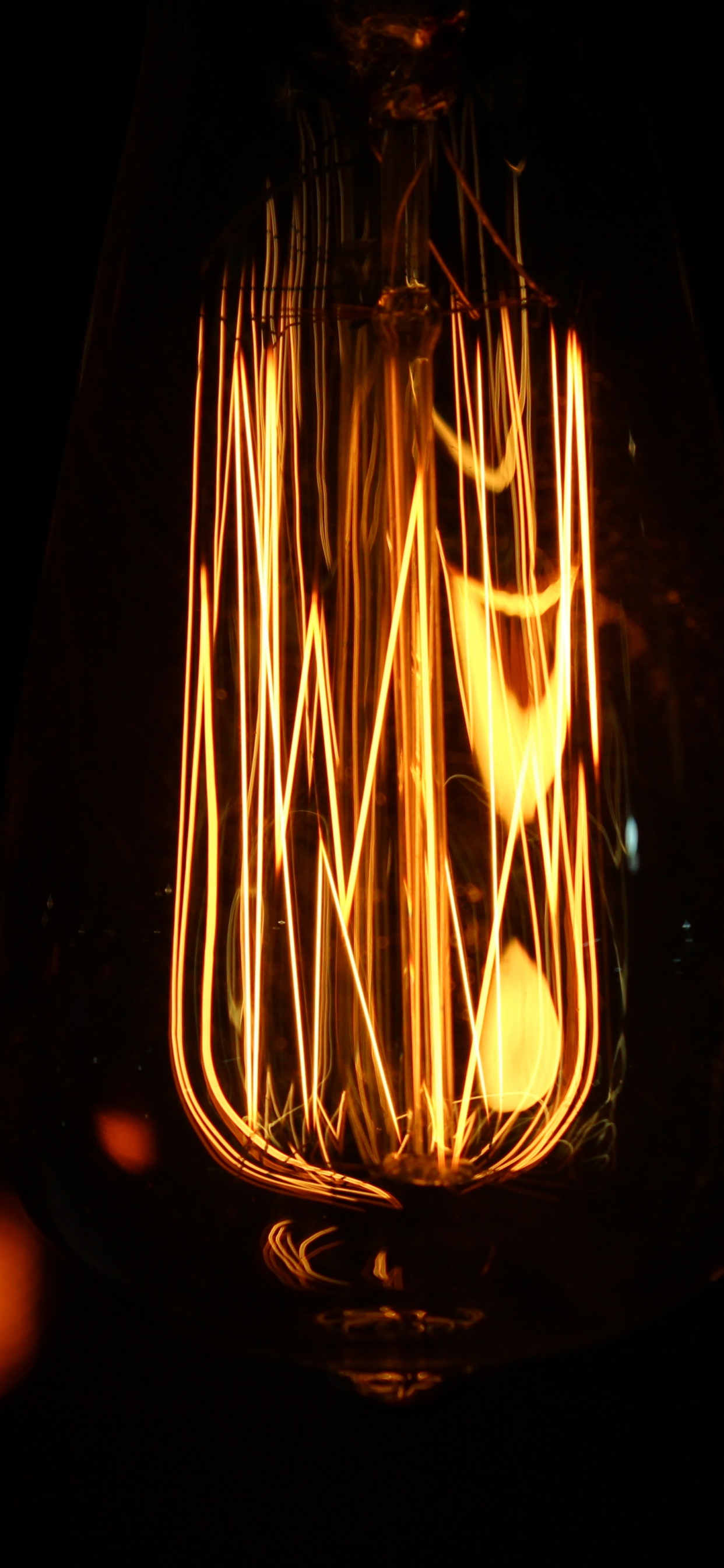 Clear Glass Light Bulb With Light. Wallpaper in 1242x2688 Resolution