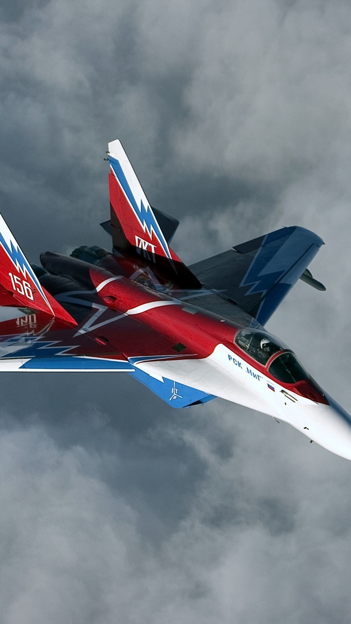 Red and White Jet Plane in Mid Air. Wallpaper in 720x1280 Resolution