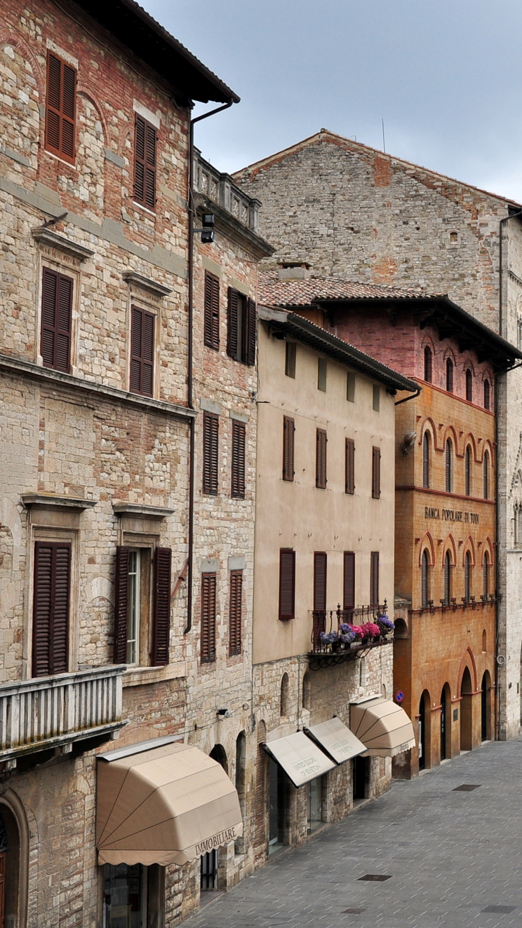 People Walking on Street Near Brown Concrete Building During Daytime. Wallpaper in 750x1334 Resolution