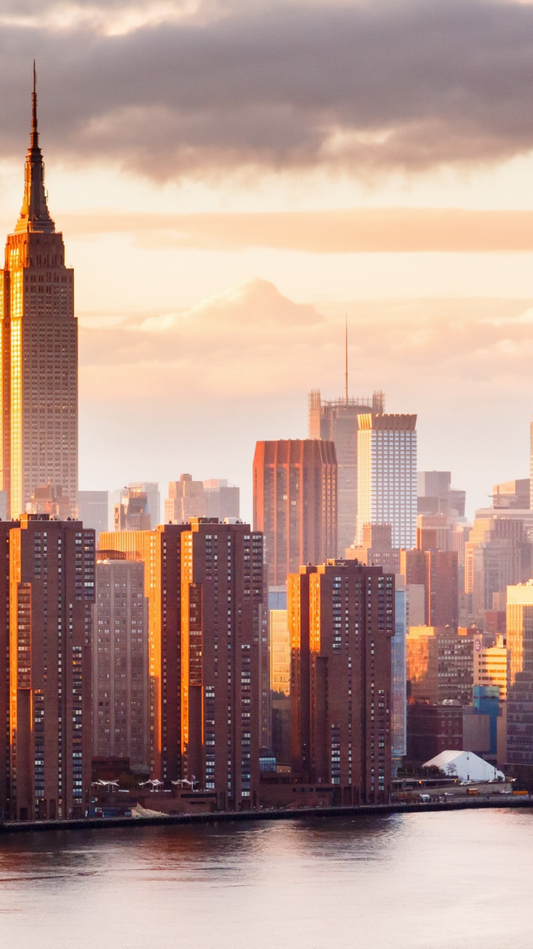 City Skyline Across Body of Water During Daytime. Wallpaper in 750x1334 Resolution
