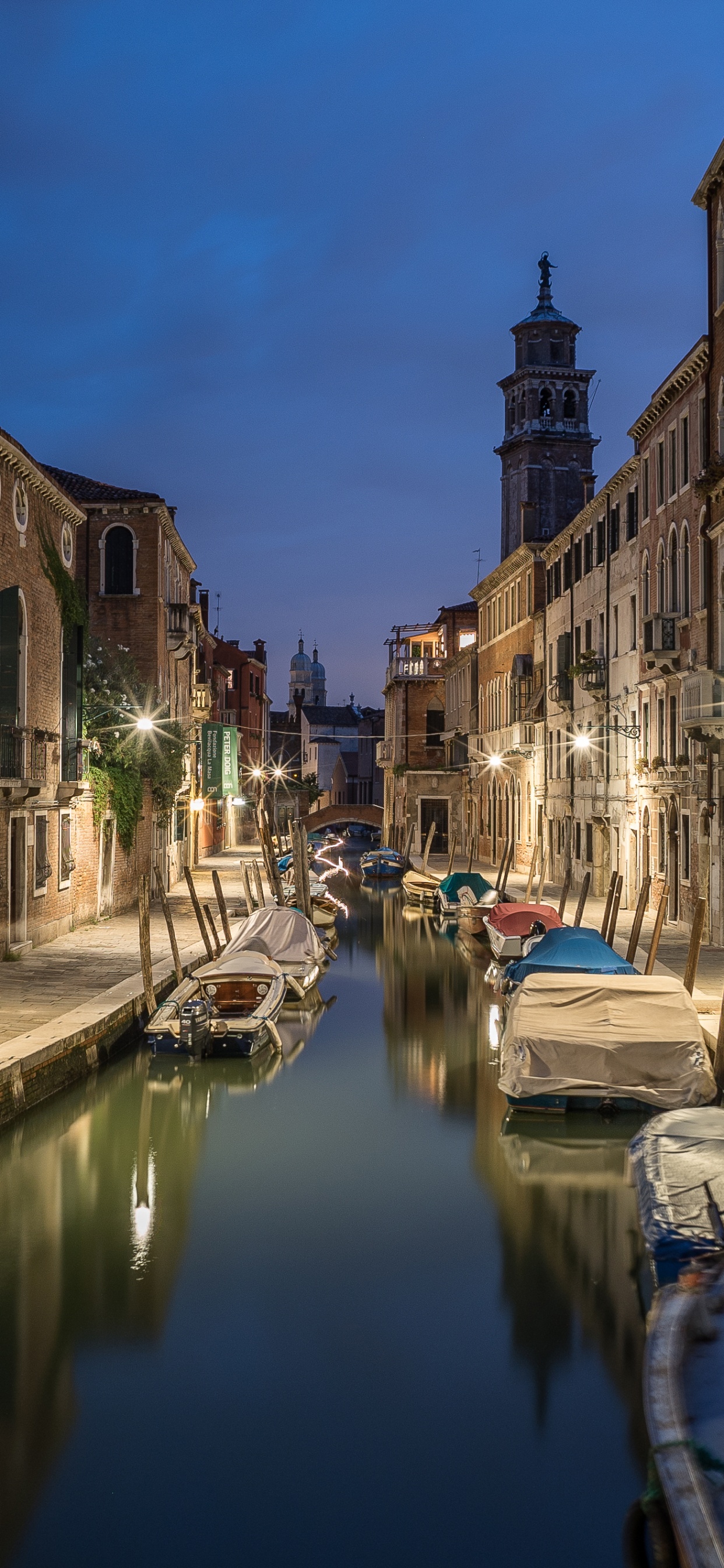 Blue Boat on River Between Buildings During Daytime. Wallpaper in 1242x2688 Resolution