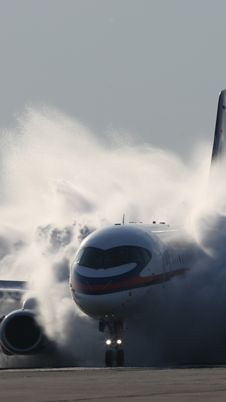 White and Red Airplane on Air During Daytime. Wallpaper in 750x1334 Resolution