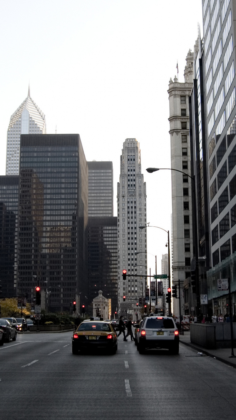 Cars on Road Between High Rise Buildings During Daytime. Wallpaper in 750x1334 Resolution