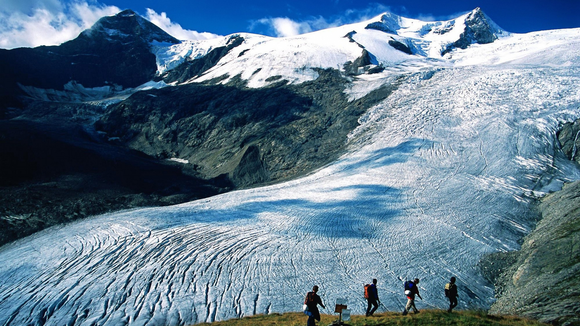 People Walking on Snow Covered Ground Near Snow Covered Mountain During Daytime. Wallpaper in 1920x1080 Resolution