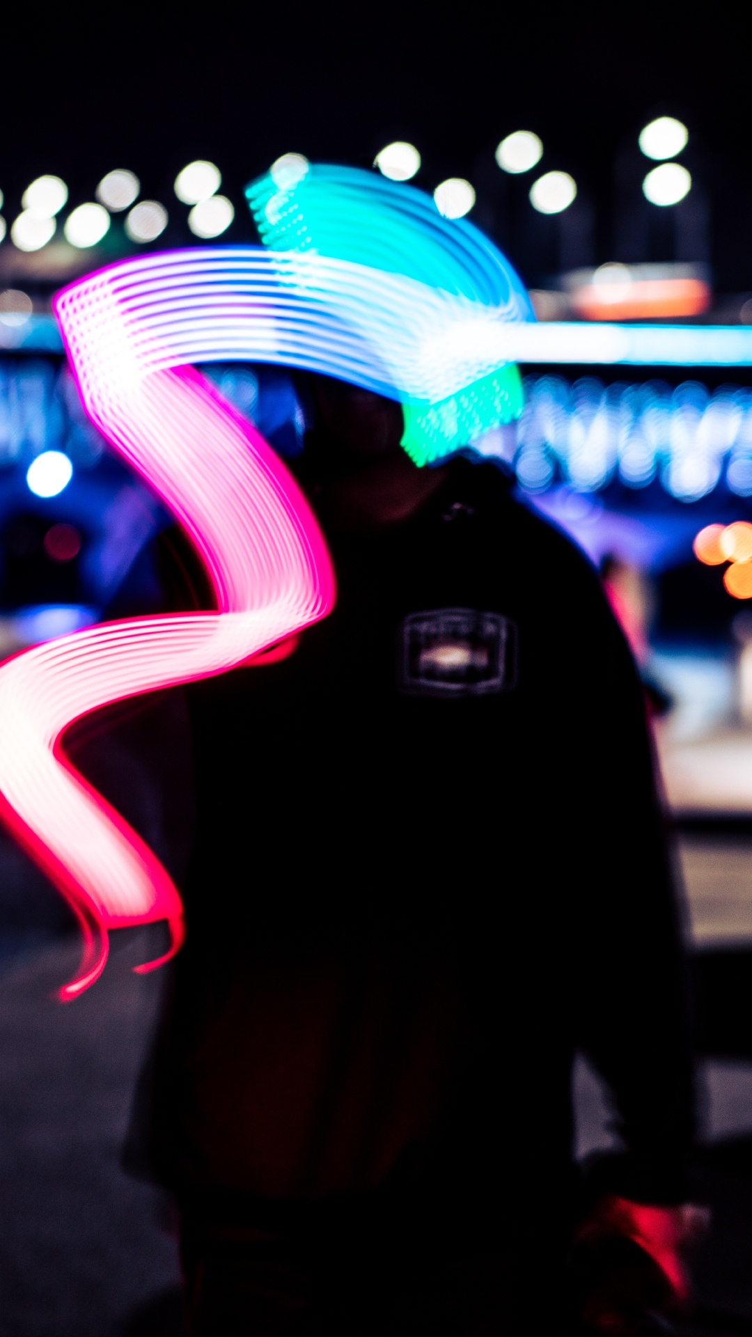 Man in Black Hoodie Standing Near Blue and White Light During Night Time. Wallpaper in 1080x1920 Resolution