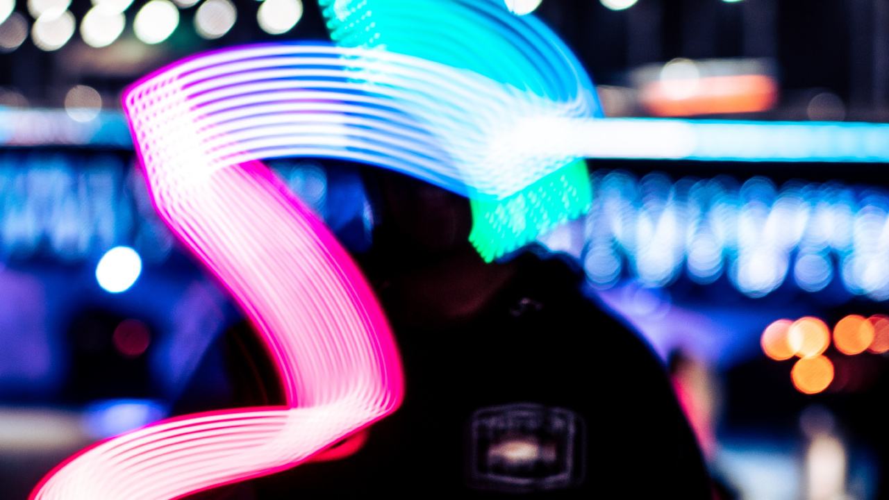 Man in Black Hoodie Standing Near Blue and White Light During Night Time. Wallpaper in 1280x720 Resolution