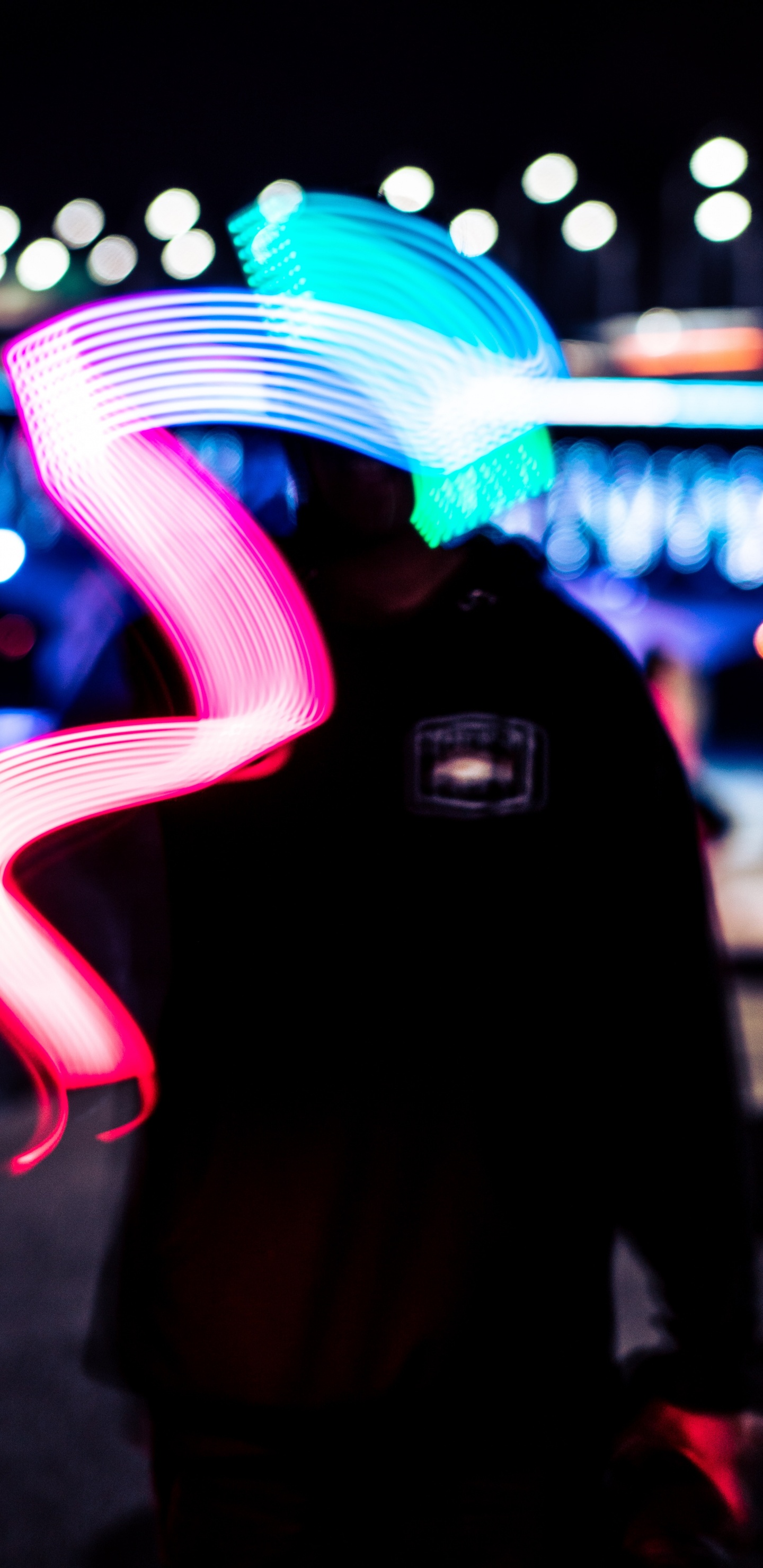 Man in Black Hoodie Standing Near Blue and White Light During Night Time. Wallpaper in 1440x2960 Resolution