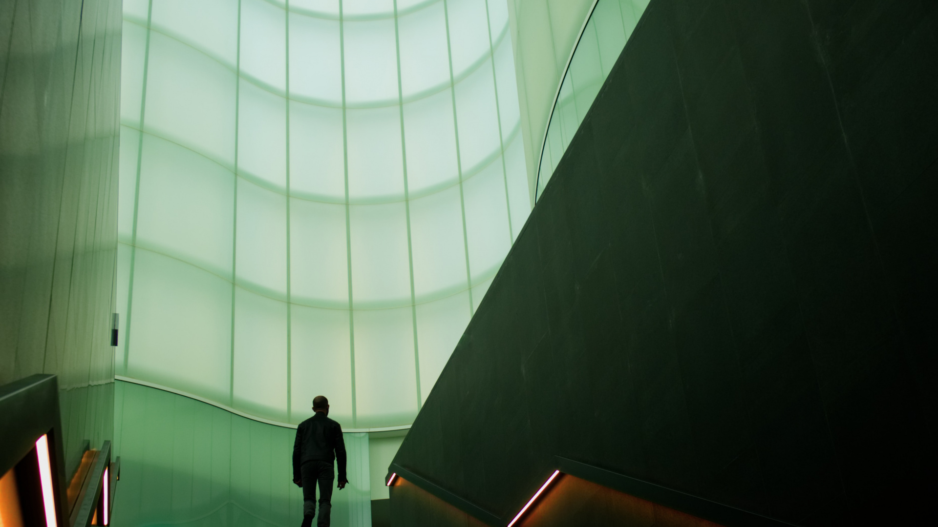 Man in Black Jacket Walking on Brown Staircase. Wallpaper in 1920x1080 Resolution