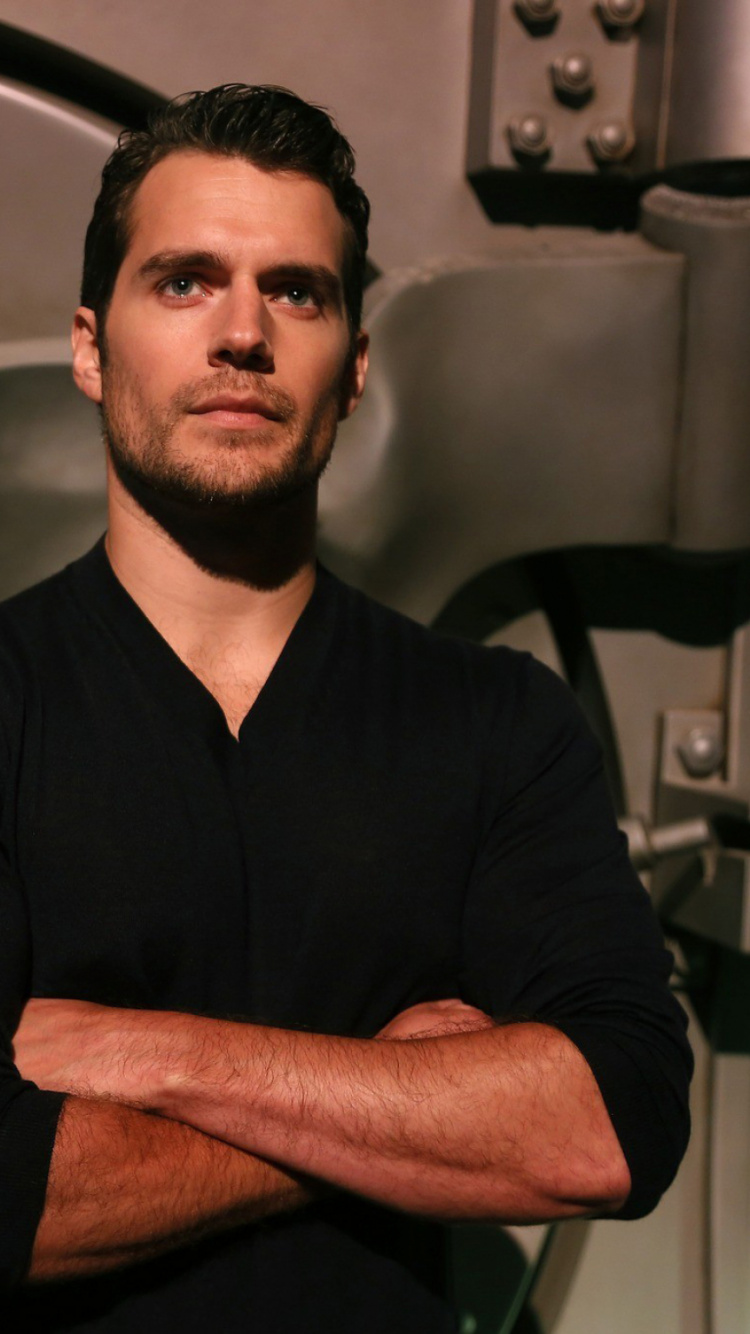 Man in Black Polo Shirt Sitting on Black Chair. Wallpaper in 750x1334 Resolution