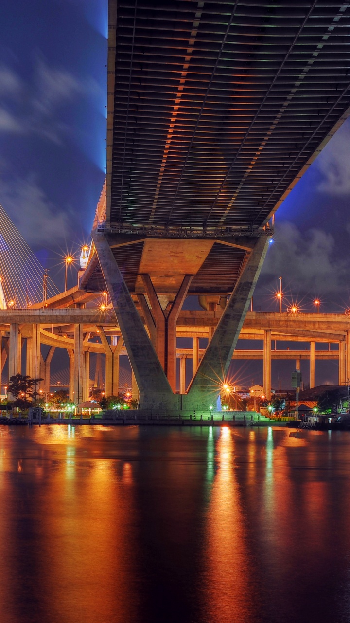 Brown Bridge Over Body of Water During Night Time. Wallpaper in 720x1280 Resolution