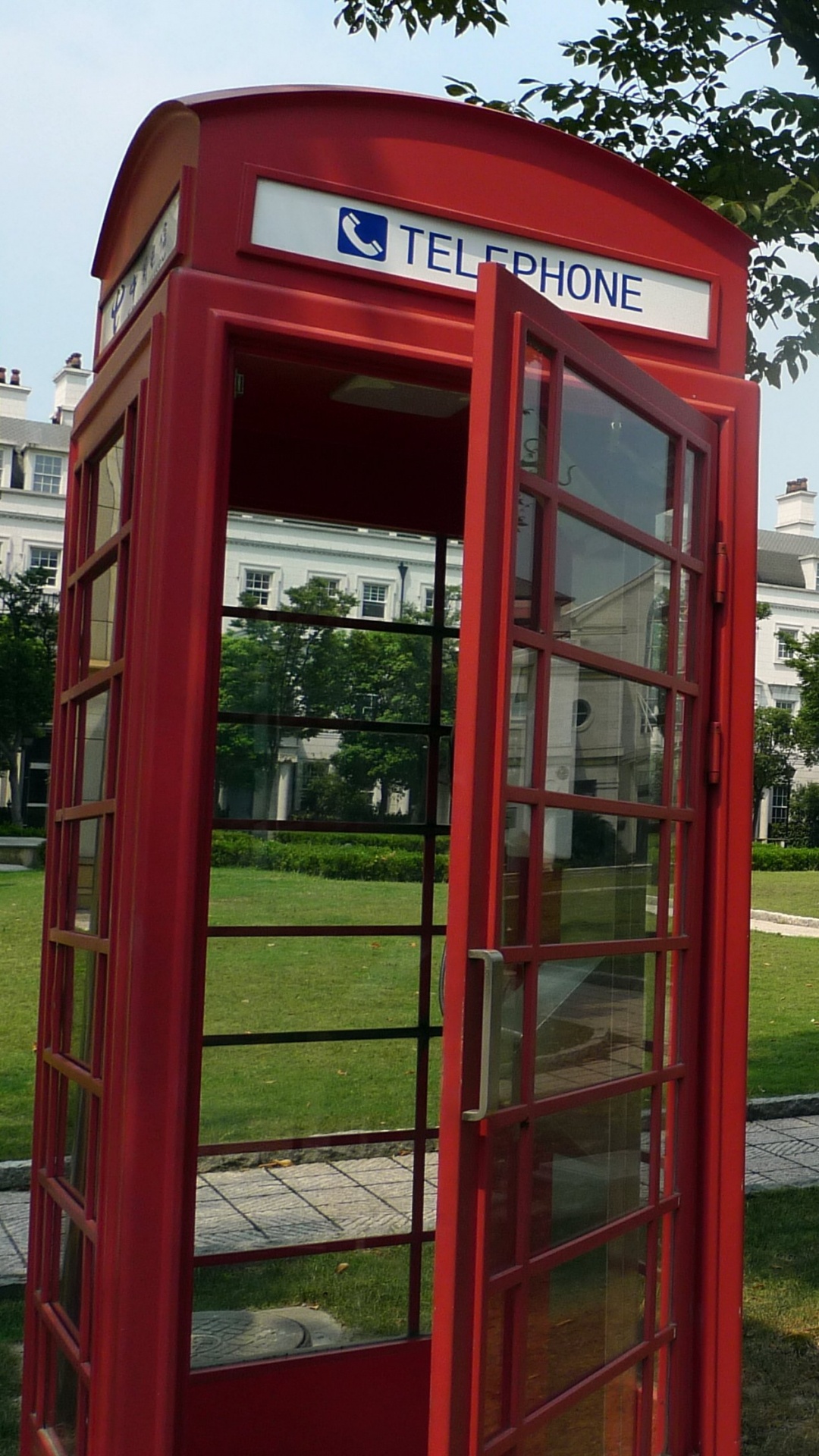 Red Telephone Booth Near Green Trees During Daytime. Wallpaper in 1080x1920 Resolution