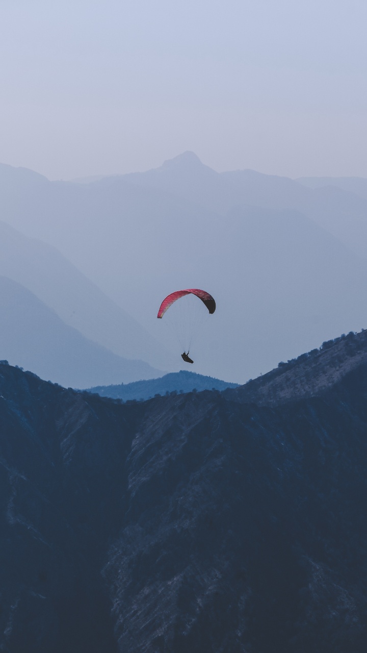 Person in Orange Parachute Over Green Mountains During Daytime. Wallpaper in 720x1280 Resolution