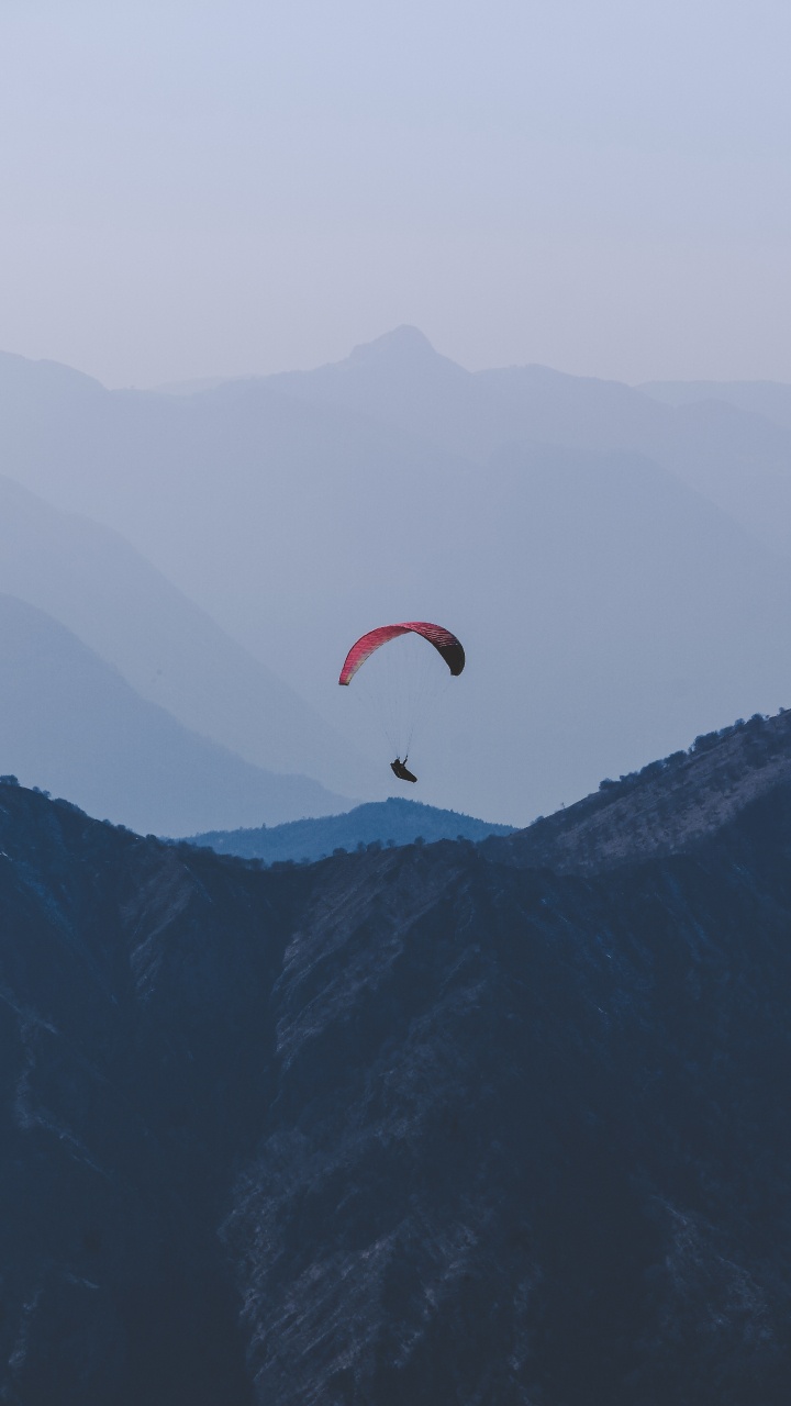 Personne en Parachute Orange Au-dessus Des Montagnes Vertes Pendant la Journée. Wallpaper in 720x1280 Resolution