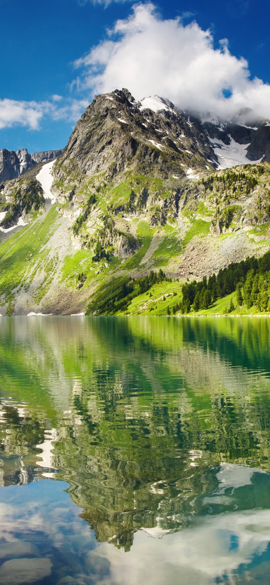 Green and White Mountains Near Lake Under Blue Sky During Daytime. Wallpaper in 1125x2436 Resolution
