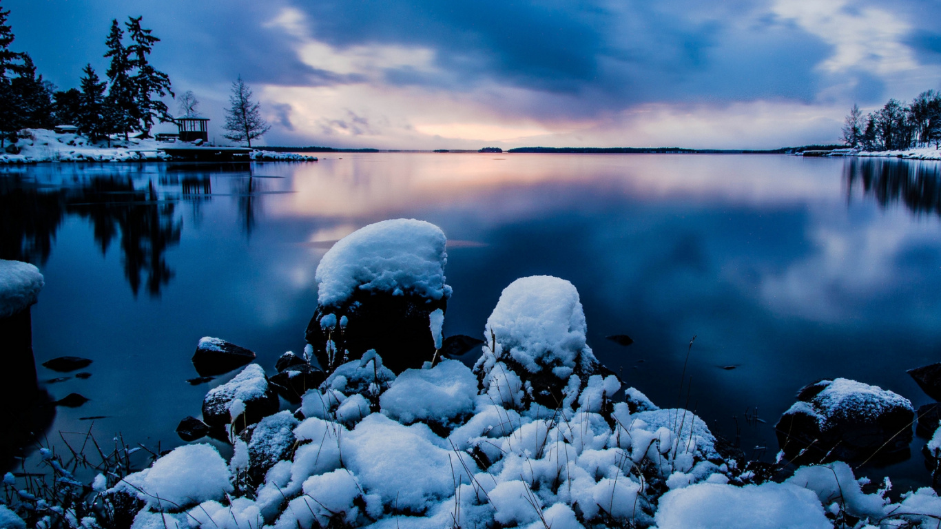 Gray Rocks on Body of Water Under Cloudy Sky During Daytime. Wallpaper in 1366x768 Resolution