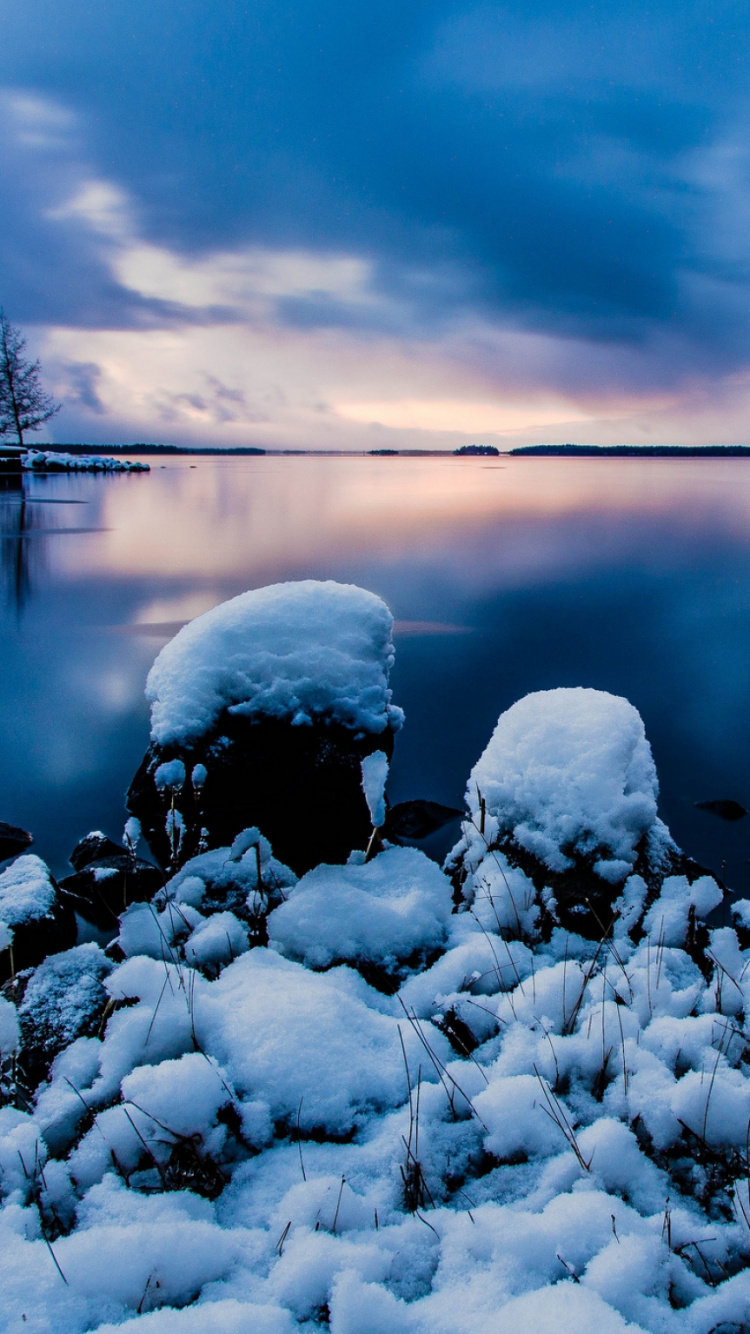 Gray Rocks on Body of Water Under Cloudy Sky During Daytime. Wallpaper in 750x1334 Resolution