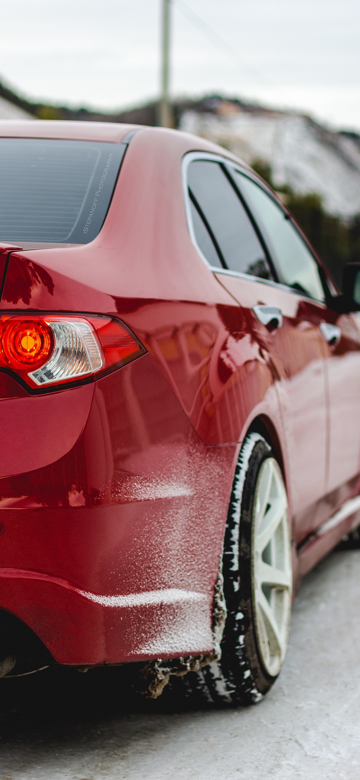 Red Car on Snow Covered Ground During Daytime. Wallpaper in 1242x2688 Resolution