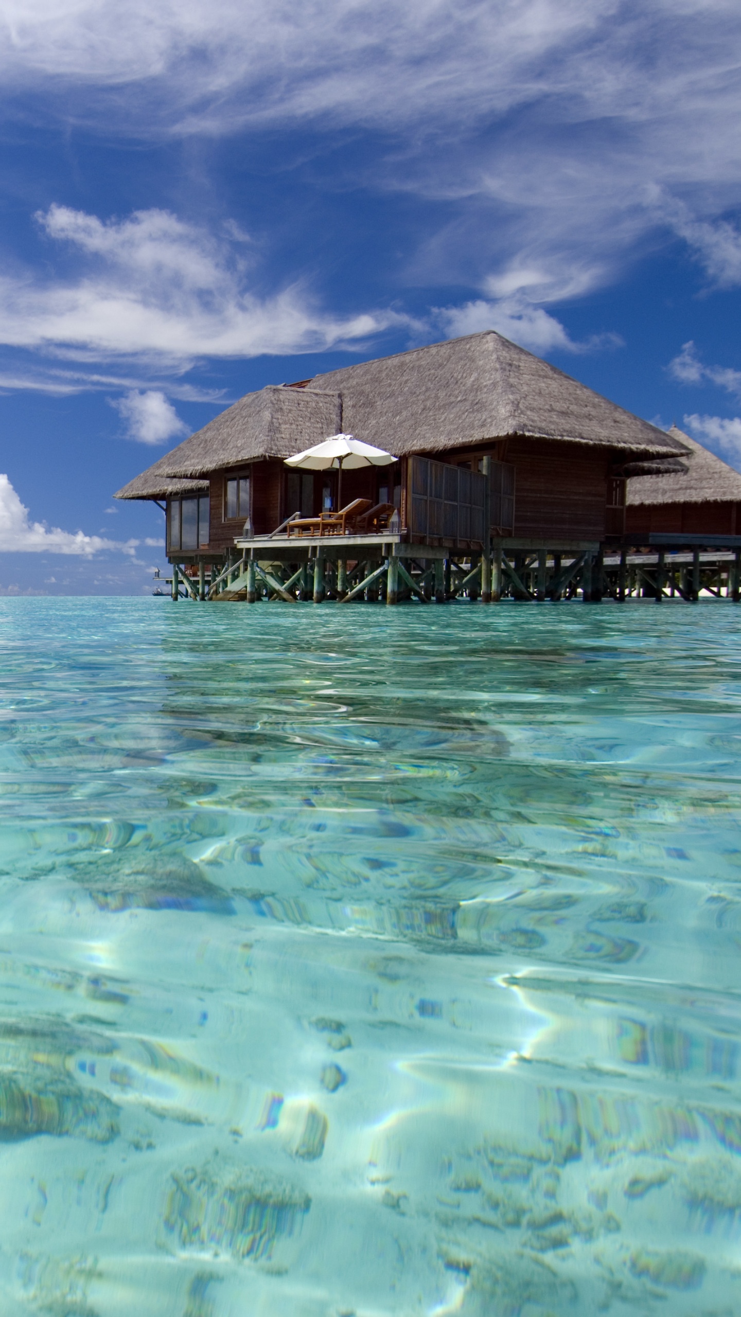 Brown Wooden House on Body of Water Under Blue Sky and White Clouds During Daytime. Wallpaper in 1440x2560 Resolution