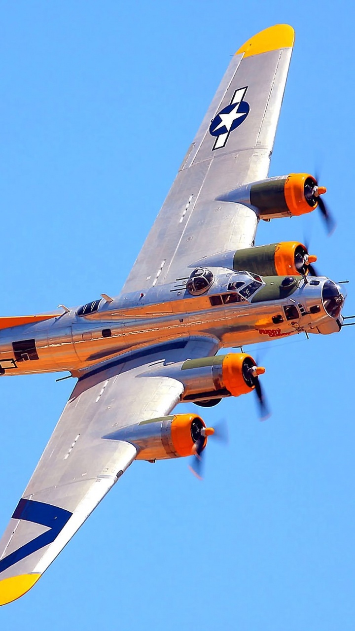 Avión de Reacción Naranja y Amarillo en el Aire Durante el Día. Wallpaper in 720x1280 Resolution