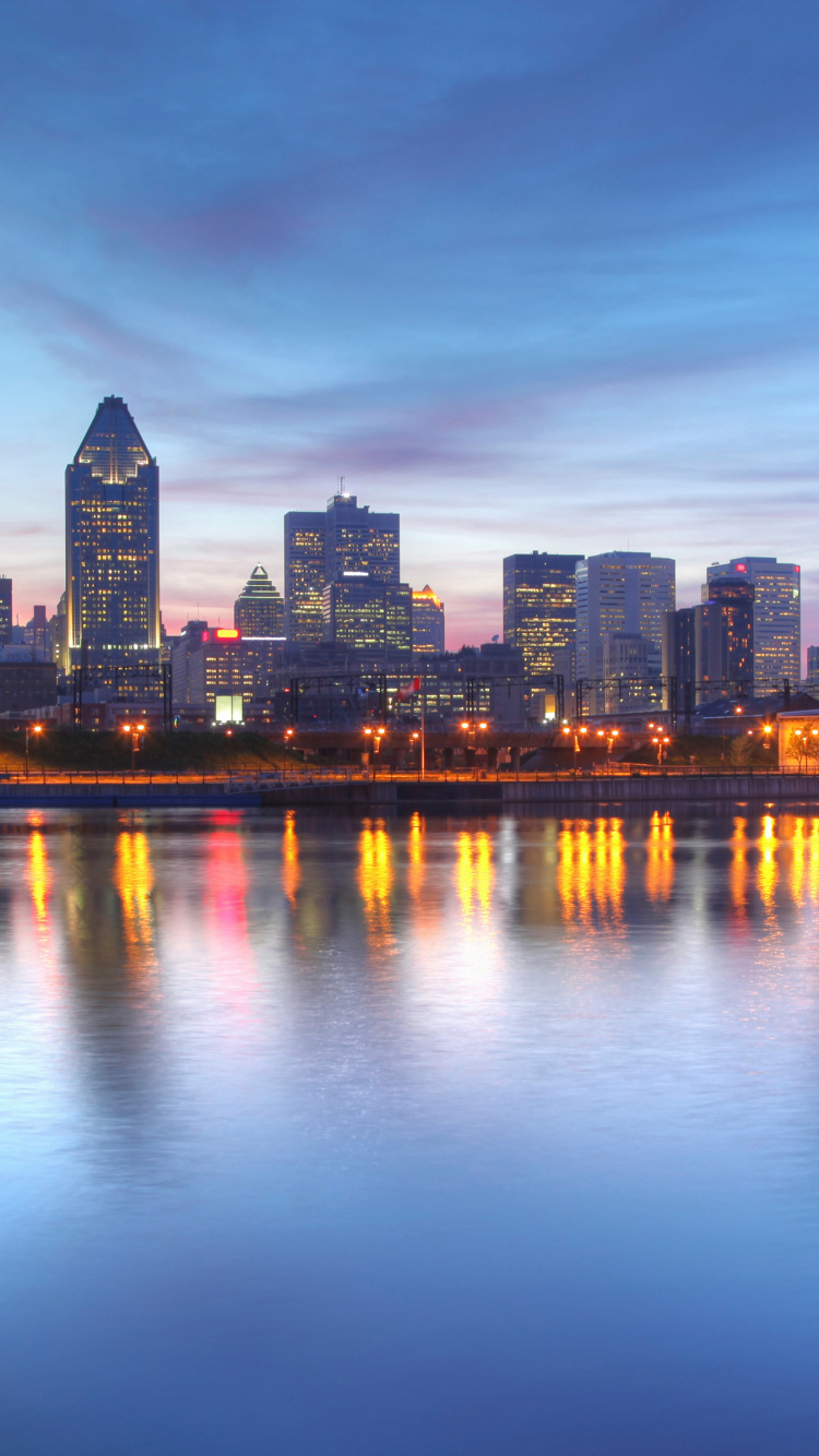 City Skyline Across Body of Water During Night Time. Wallpaper in 750x1334 Resolution