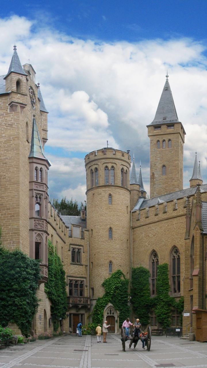 Gente Caminando Cerca Del Edificio de Hormigón Marrón Durante el Día. Wallpaper in 720x1280 Resolution