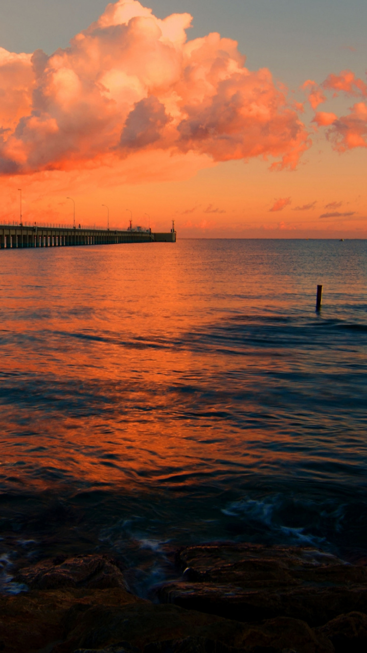Vagues de la Mer se Brisant Sur le Rivage Pendant le Coucher du Soleil. Wallpaper in 750x1334 Resolution