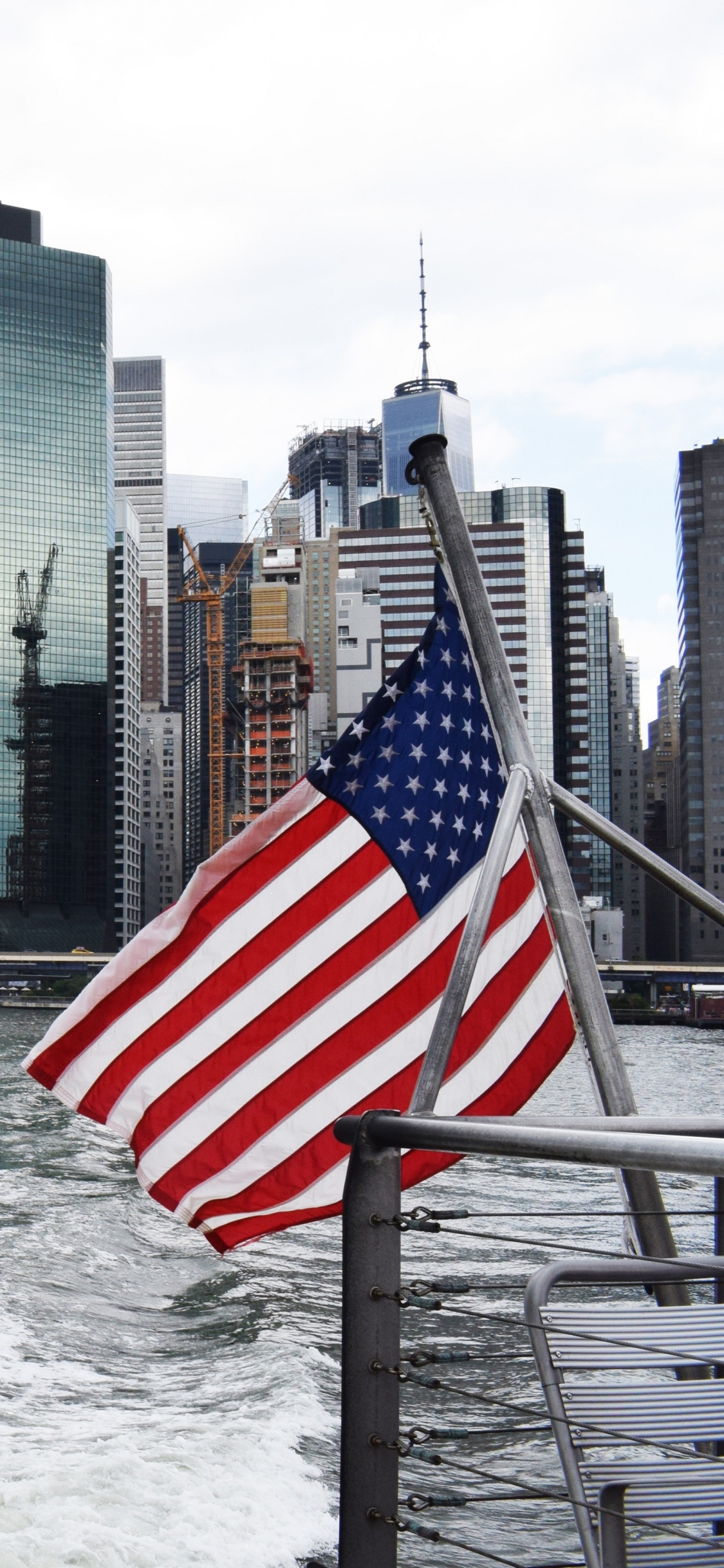 City Skyline Across Body of Water During Daytime. Wallpaper in 1125x2436 Resolution