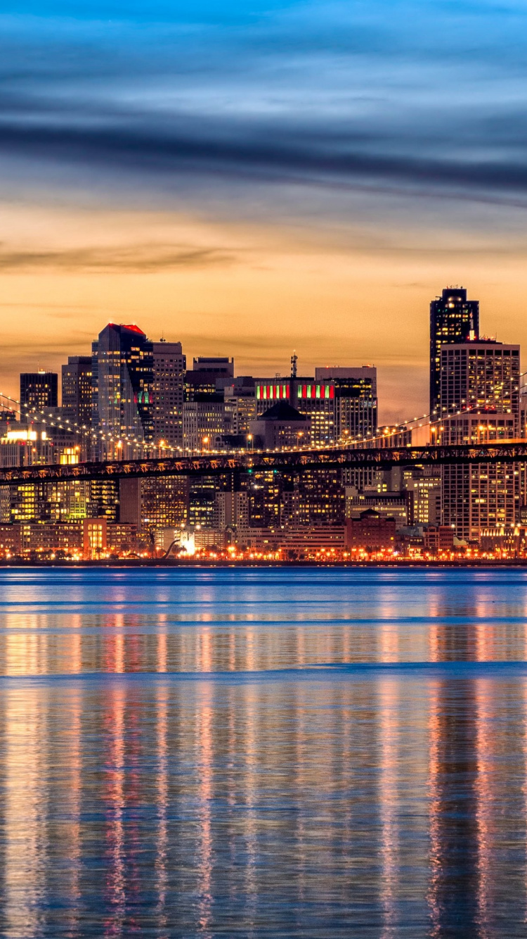 City Skyline Across Body of Water During Night Time. Wallpaper in 750x1334 Resolution