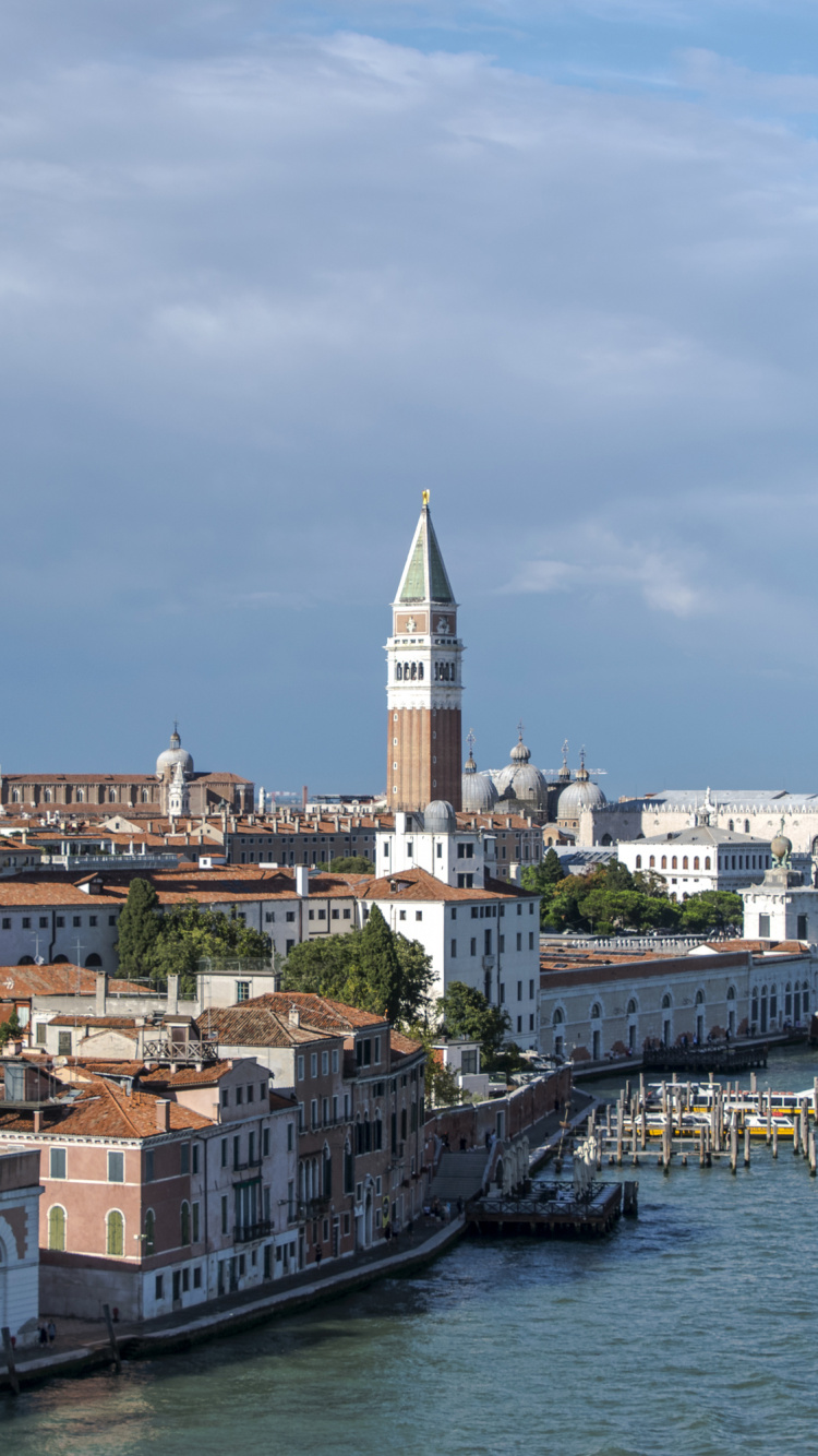 White and Brown Concrete Building Near Body of Water During Daytime. Wallpaper in 750x1334 Resolution