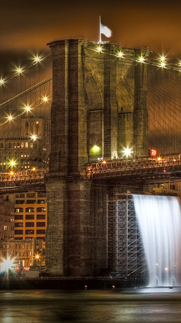 Lighted Bridge Near City Buildings During Night Time. Wallpaper in 720x1280 Resolution