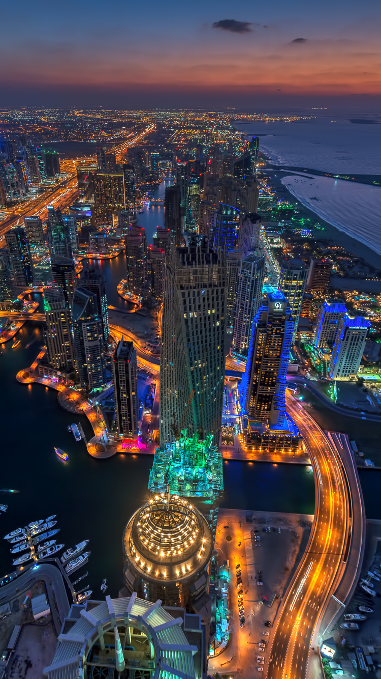 Vista Aérea de la Ciudad Durante la Noche.. Wallpaper in 750x1334 Resolution