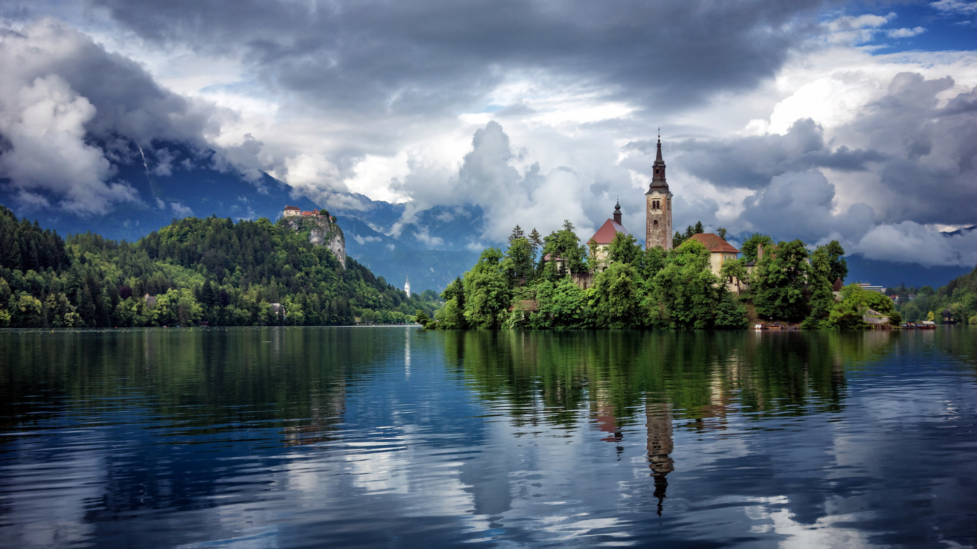 Brown Concrete Building Near Body of Water Under White Clouds and Blue Sky During Daytime. Wallpaper in 1920x1080 Resolution